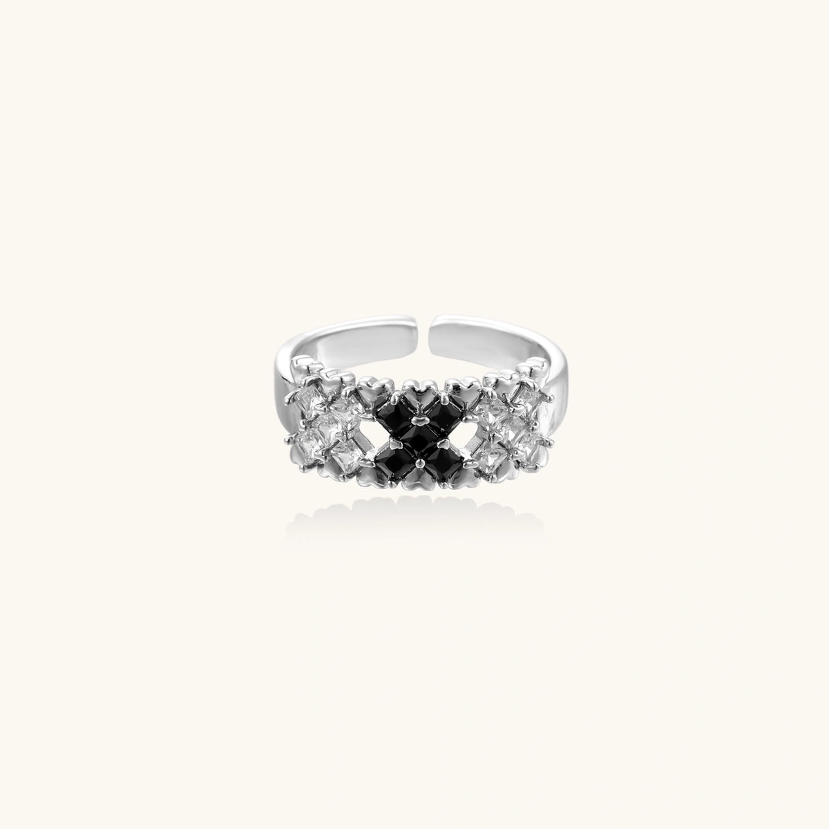 Adjustable white gold plated ring with geometric grid of black and clear zirconia stones in checkerboard pattern