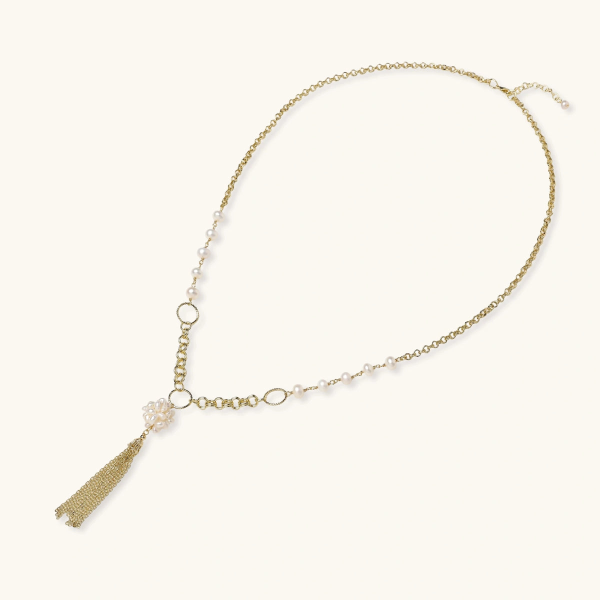 Long gold-plated necklace with freshwater pearls, chunky chain links, and flowing tassel pendant