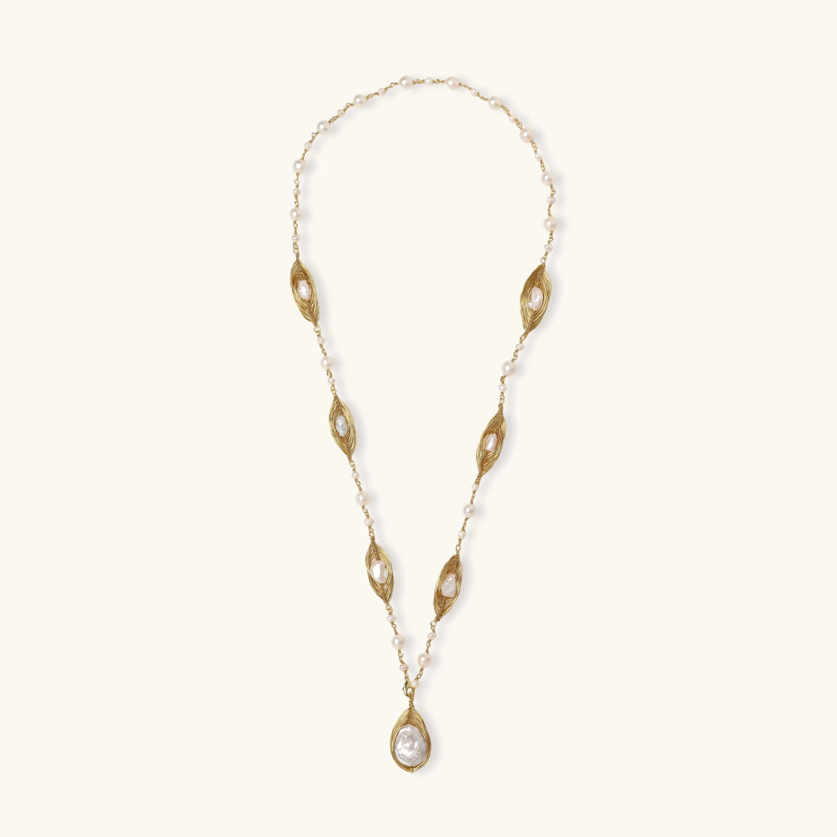 14K gold plated necklace with organic leaf motifs and freshwater pearls arranged in an elegant chain design on neutral background.